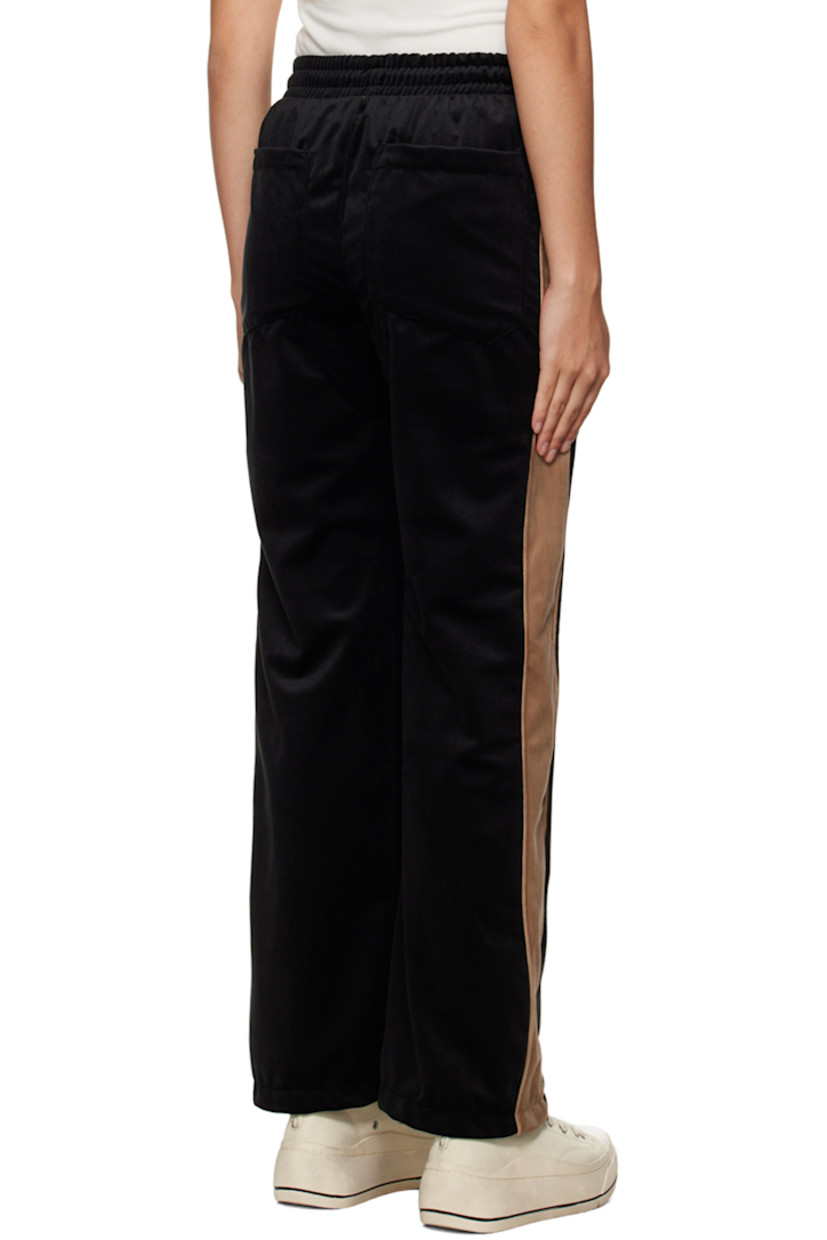 Polyester velour lounge pants.

· Drawstring at elasticized waistband
· Four-pocket styling
· Mock-fly 
· Logo graphic embroidered at leg
· Striped trim at outseams

Supplier color: Black/Khaki