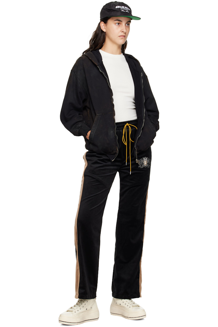 Polyester velour lounge pants.

· Drawstring at elasticized waistband
· Four-pocket styling
· Mock-fly 
· Logo graphic embroidered at leg
· Striped trim at outseams

Supplier color: Black/Khaki