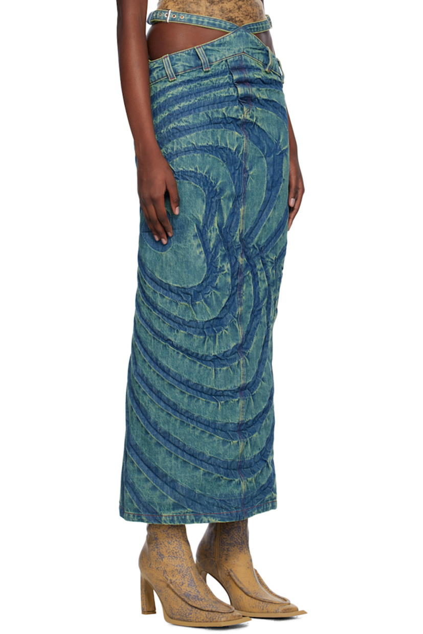 Bias-cut non-stretch denim skirt. Fading and creased graphics throughout.

· Asymmetrical construction
· Pin-buckle straps and cutouts at waist
· Belt loops
· Mock-fly
· Vent at back
· Contrast stitching in red

Supplier color: Fern