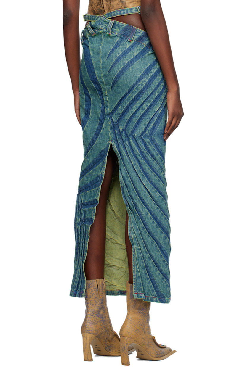 Bias-cut non-stretch denim skirt. Fading and creased graphics throughout.

· Asymmetrical construction
· Pin-buckle straps and cutouts at waist
· Belt loops
· Mock-fly
· Vent at back
· Contrast stitching in red

Supplier color: Fern