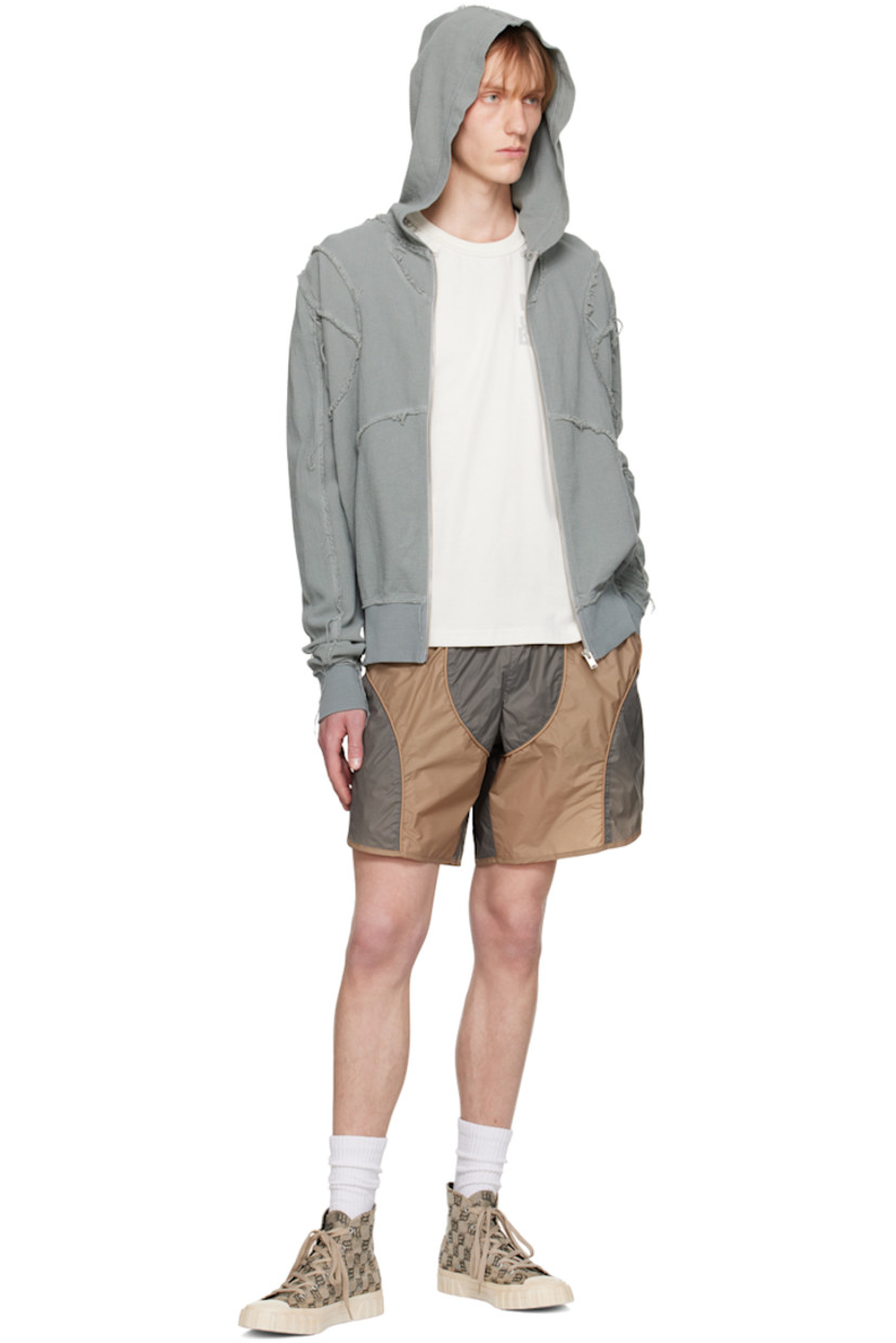 Nylon taffeta shorts. Piping throughout. 

· Paneled construction
· Logo embroidered at elasticized waistband 
· Two-pocket styling
· Zip-fly 
· Vented outseam 
· Briefs-style mesh lining 
· Logo-engraved antiqued silver-tone hardware

Part of the MISBHV x Jordan Barrett collaboration. 

Supplier color: Grey