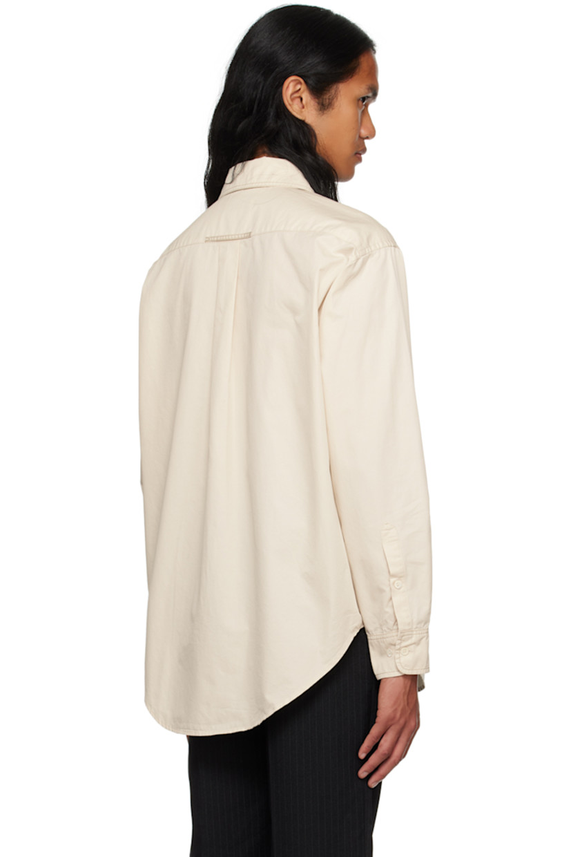 Cotton poplin shirt.

· Spread collar
· Button closure
· Patch pocket
· Shirttail hem
· Adjustable two-button barrel cuffs
· Locker loop and box pleat at back yoke
· Contrast stitching in gray
· Shell hardware

Supplier color: Chalk