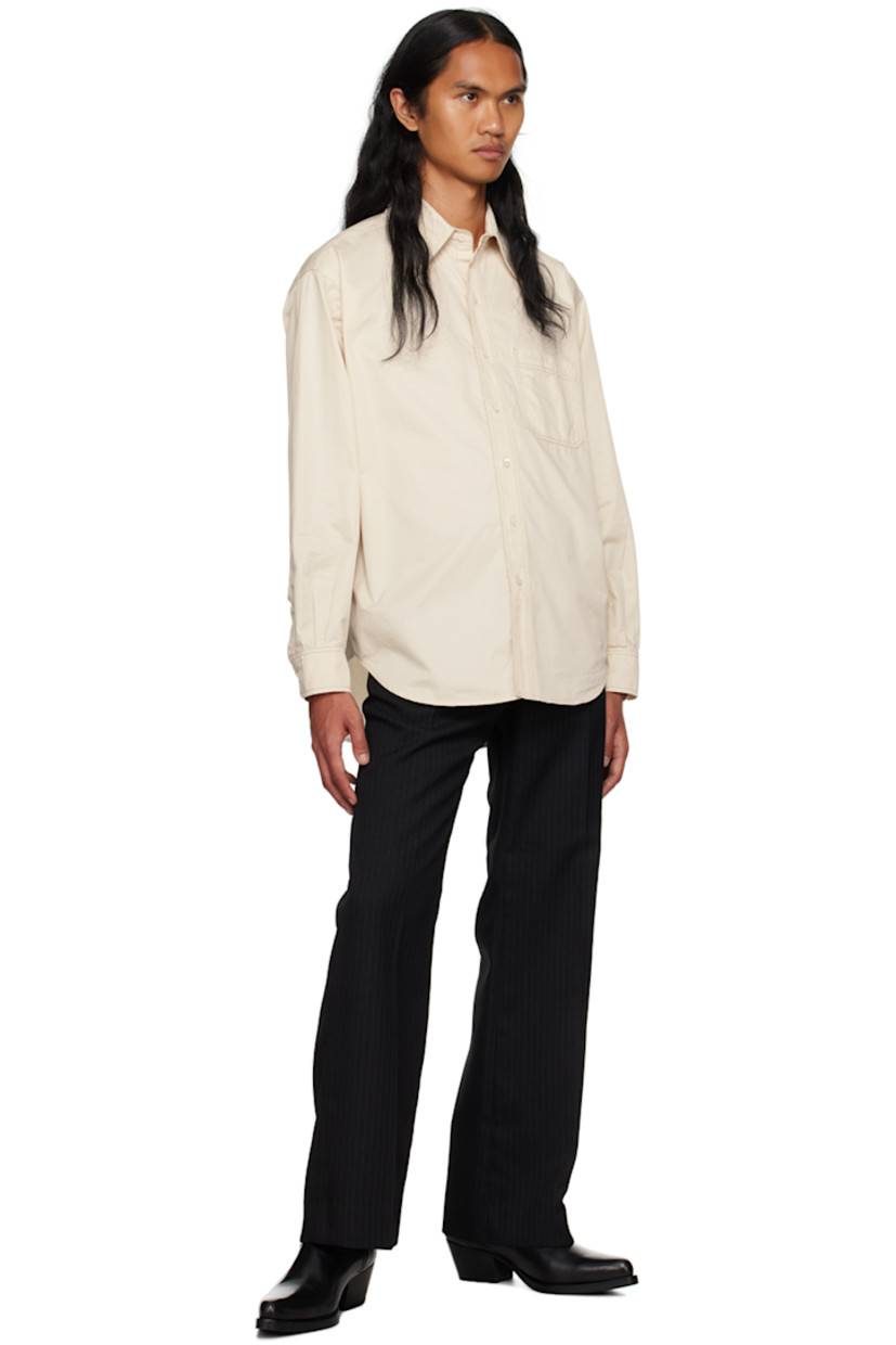 Cotton poplin shirt.

· Spread collar
· Button closure
· Patch pocket
· Shirttail hem
· Adjustable two-button barrel cuffs
· Locker loop and box pleat at back yoke
· Contrast stitching in gray
· Shell hardware

Supplier color: Chalk