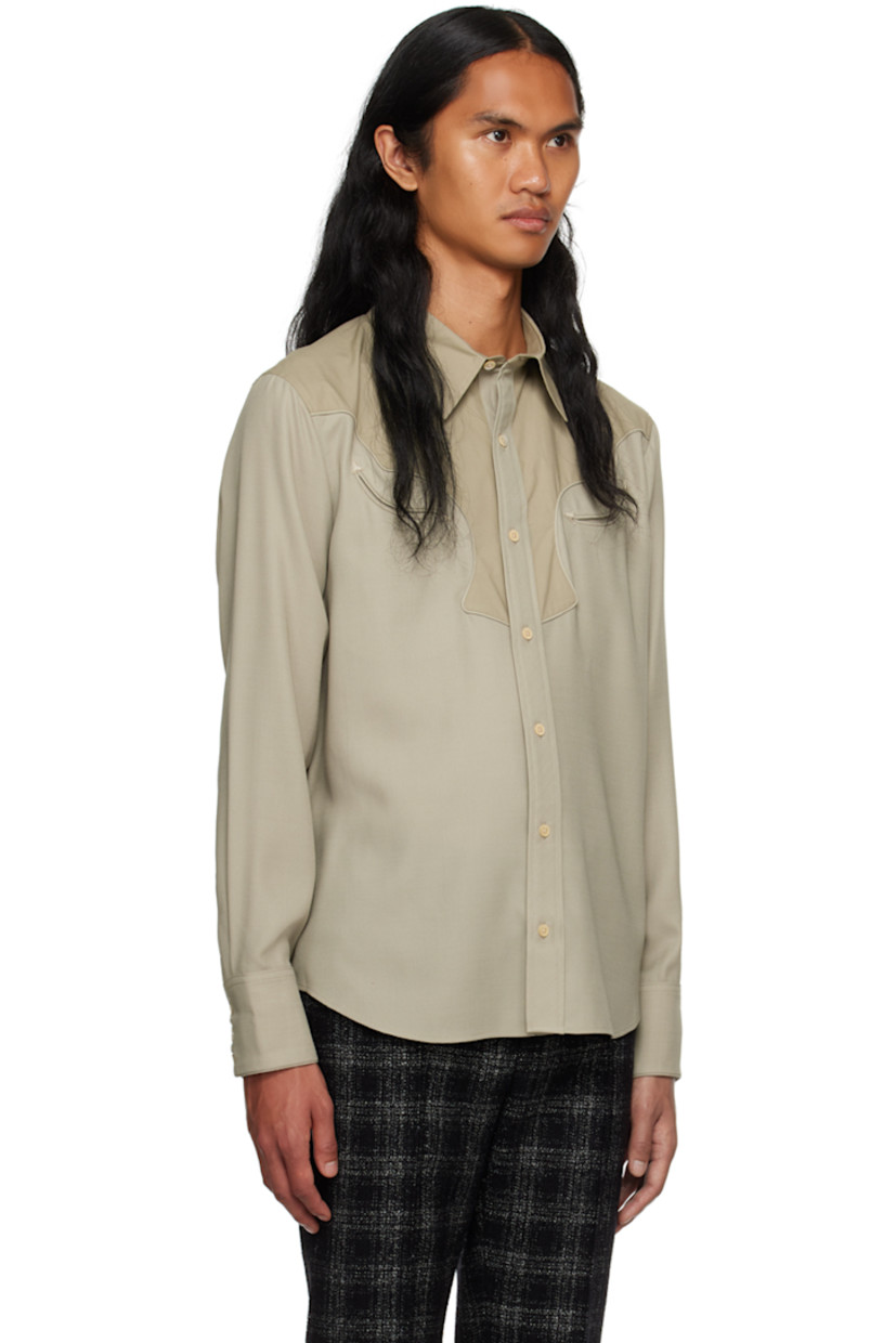 Paneled wool delaine and cotton poplin shirt.

· Spread collar
· Button closure
· Welt pockets at chest
· Scalloped seam at front and back yoke 
· Shirttail hem
· Adjustable three-button barrel cuffs
· Partial charmeuse lining

Supplier color: Mist
