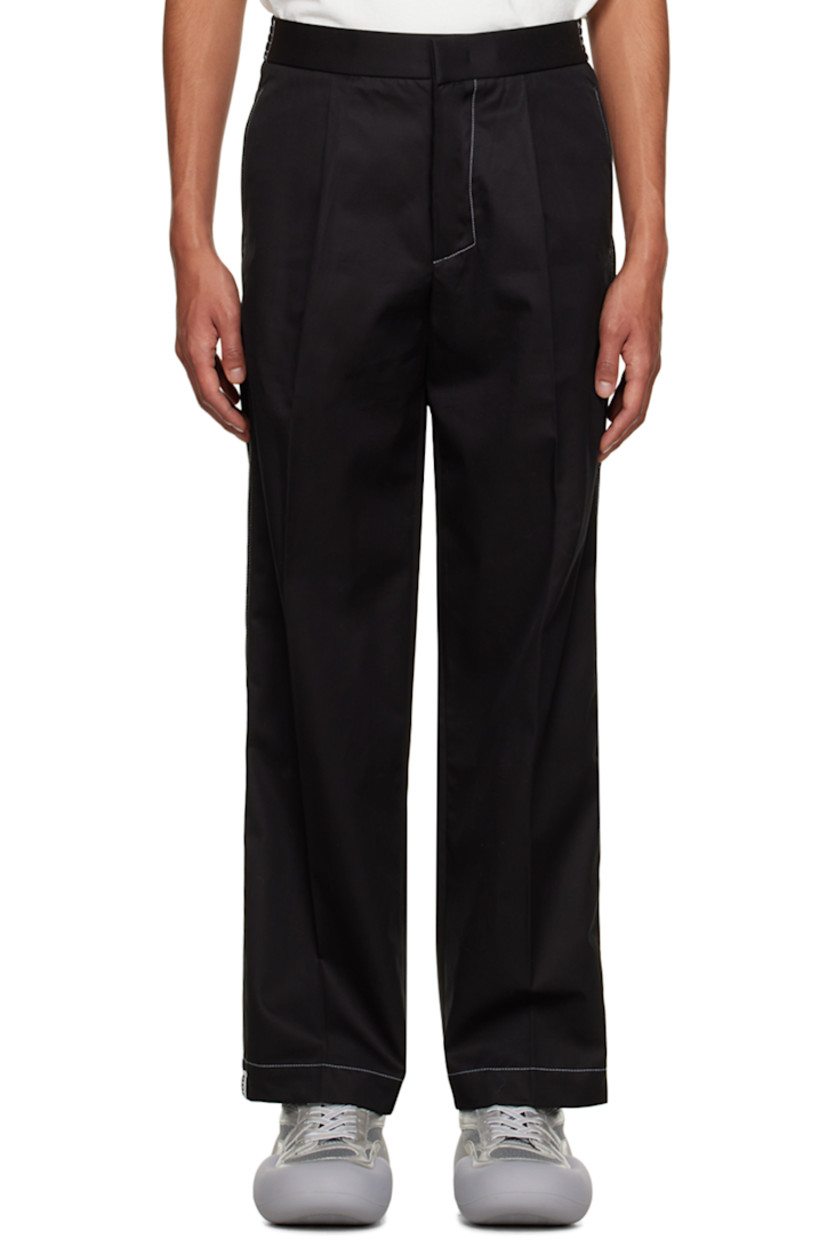 Cotton twill trousers.

· Pleats at partially elasticized waistband
· Four-pocket styling
· Zip-fly
· Creased legs
· Contrast stitching in white

Supplier color: Black/Black