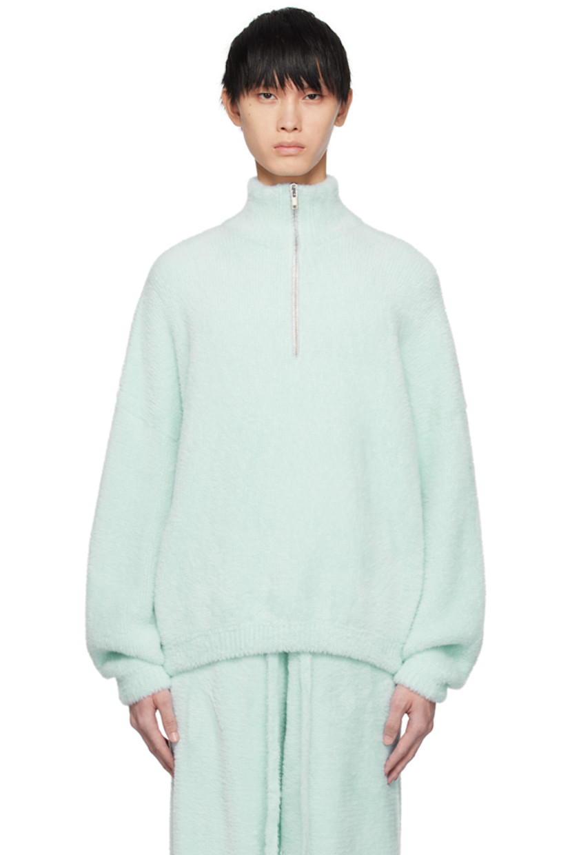 Shag knit nylon sweater. 

· Rib knit stand collar, hem, and cuffs
· Half-zip closure
· Dropped shoulders

Supplier color: Ice ice