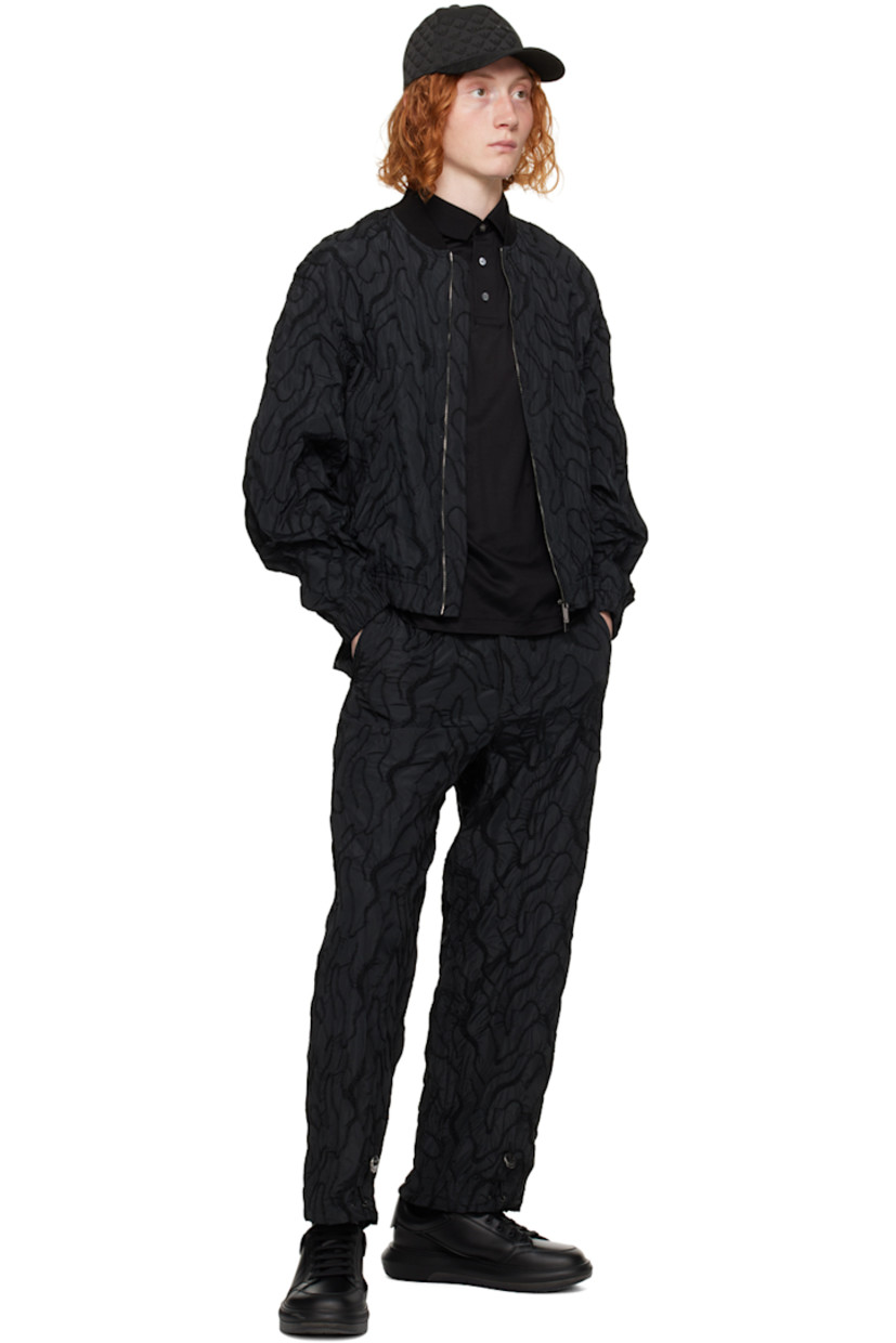 Polyester taffeta trousers. Graphic pattern embroidered throughout. 

· Bungee-style drawstring at waistband and cuffs
· Three-pocket styling 
· Button-fly 

Supplier color: Nero