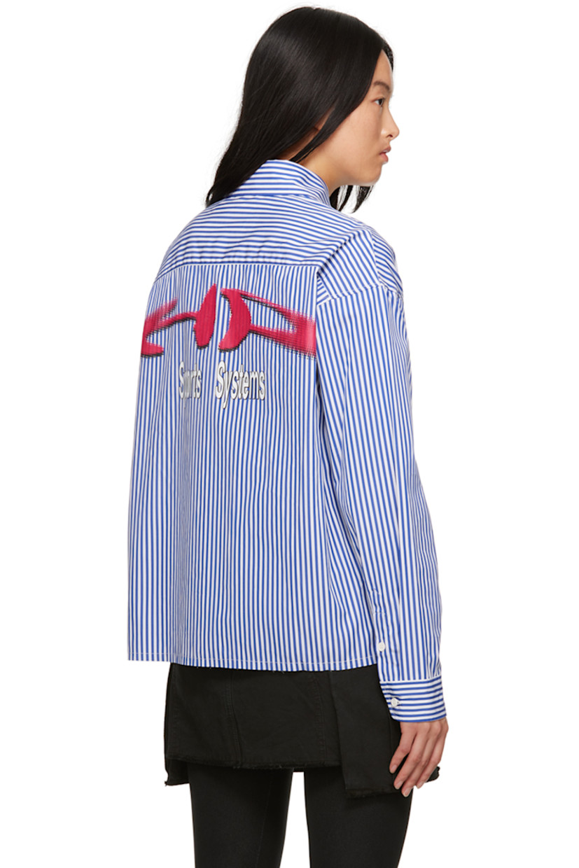 Cotton poplin shirt. Stripes throughout.

· Spread collar
· Button closure
· Patch pocket at chest
· Shirttail hem
· Single-button barrel cuffs
· Logo patch at cuff
· Graphic and text printed at back

Supplier color: Blue/Fuchsia