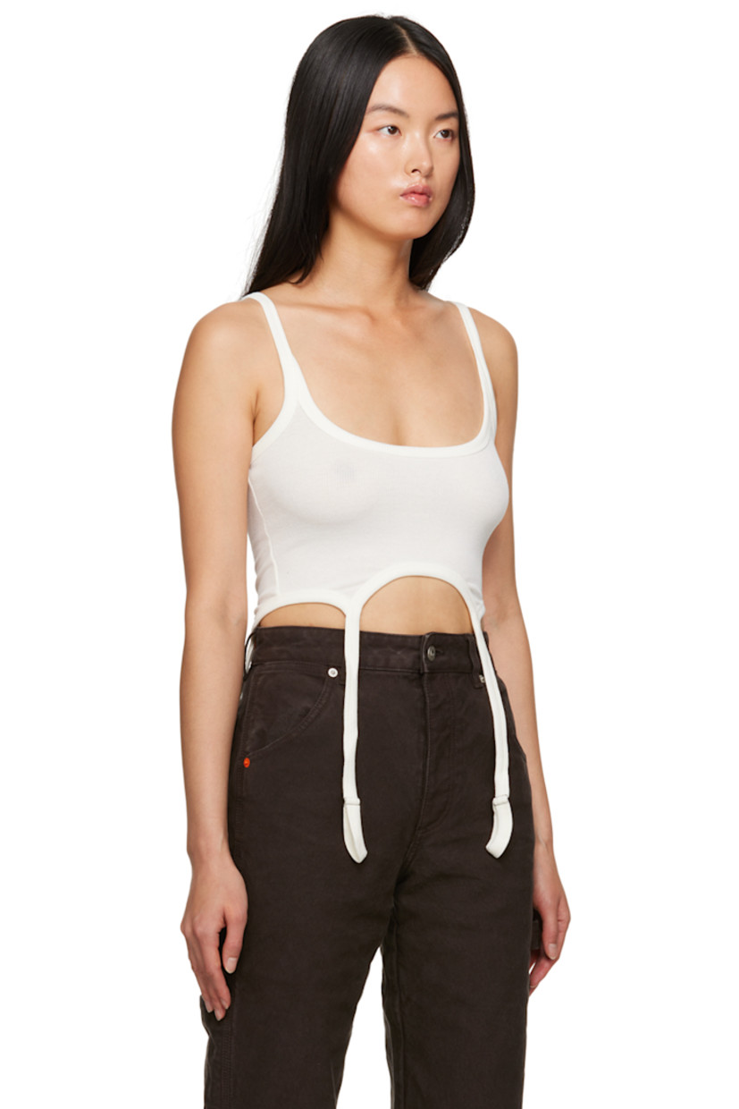 Stretch organic cotton ribbed jersey tank top. 

· Scoop neck
· Garter straps at asymmetric hem
· Logo patch at back collar

Supplier color: Ivory