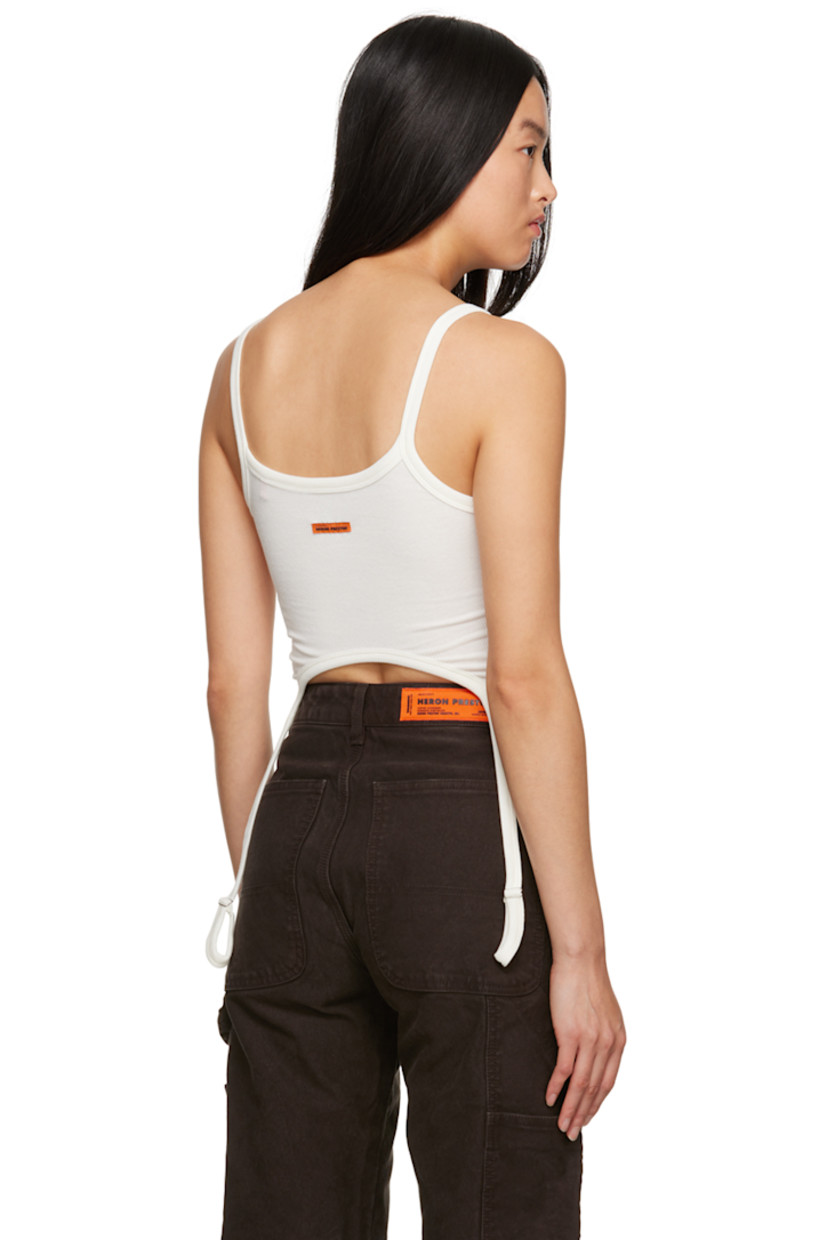 Stretch organic cotton ribbed jersey tank top. 

· Scoop neck
· Garter straps at asymmetric hem
· Logo patch at back collar

Supplier color: Ivory