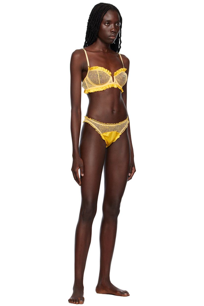 Sheer polyester tulle bra. Ruffled silk satin trim and graphic pattern flocked throughout.

· Square neck
· Cutout at front
· Underwire at cups
· Adjustable elasticized shoulder straps
· Adjustable hook-eye closure at back

Supplier color: Yellow