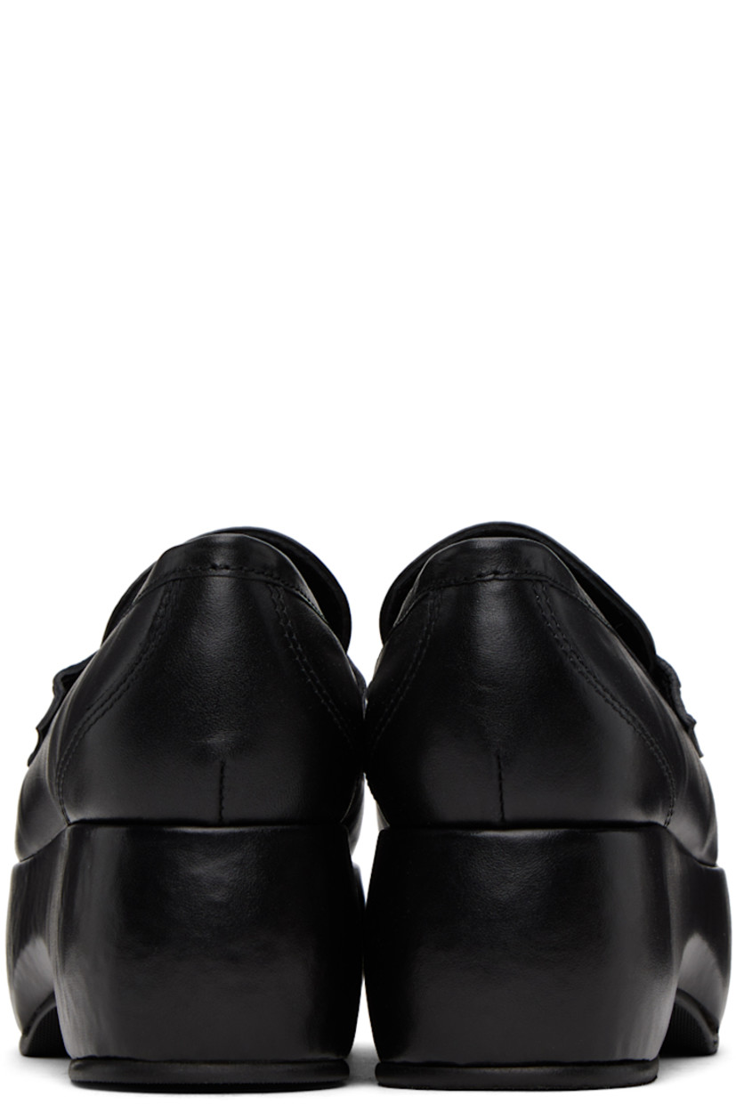Buffed leather loafers in black.

· Moc toe
· Strap with cutout at vamp
· Grained leather lining 
· Covered platform midsole
· Treaded rubber sole
· Platform: H2.25"

Supplier color: Black