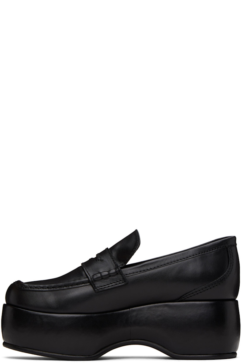 Buffed leather loafers in black.

· Moc toe
· Strap with cutout at vamp
· Grained leather lining 
· Covered platform midsole
· Treaded rubber sole
· Platform: H2.25"

Supplier color: Black