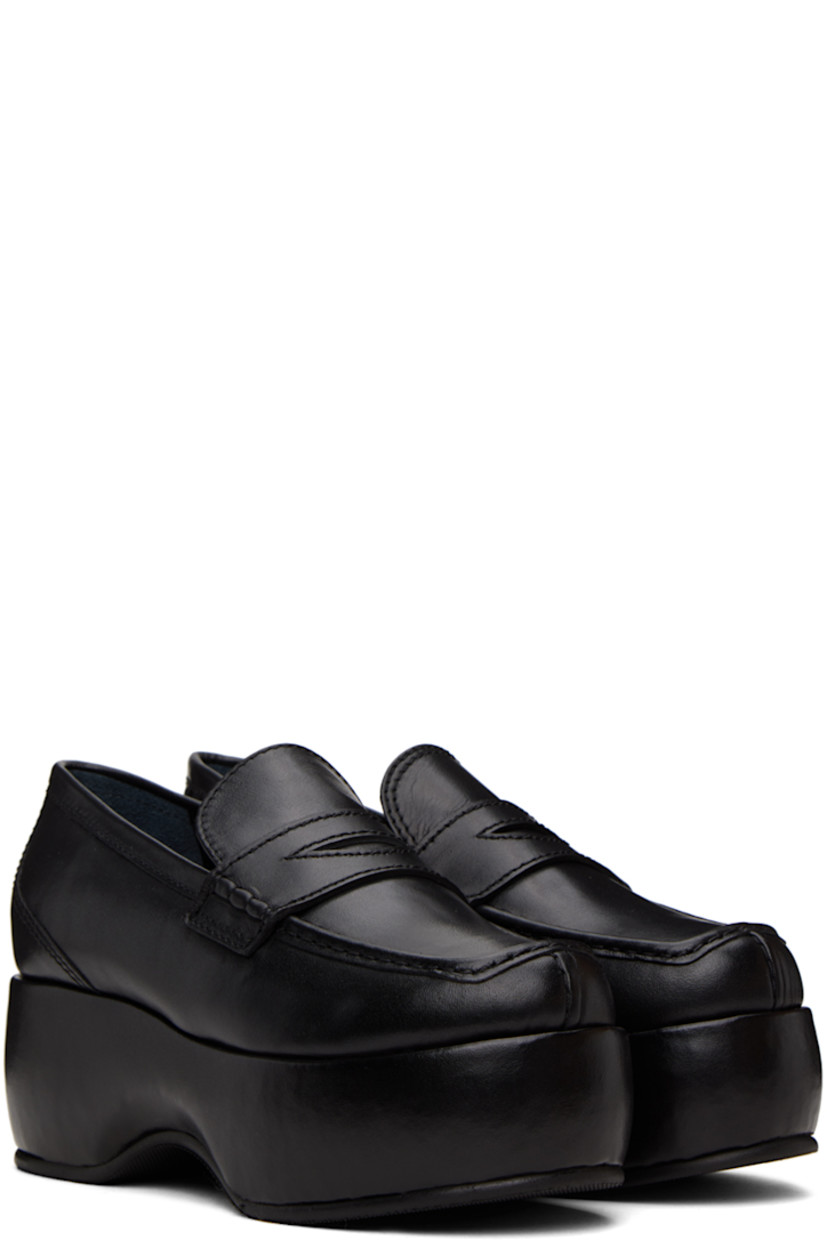 Buffed leather loafers in black.

· Moc toe
· Strap with cutout at vamp
· Grained leather lining 
· Covered platform midsole
· Treaded rubber sole
· Platform: H2.25"

Supplier color: Black