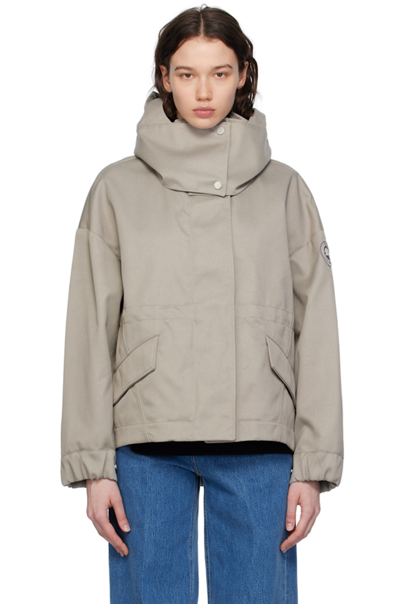 Polyester- and cotton-blend twill jacket.

· Detachable hood at stand collar
· Two-way zip closure with press-stud placket
· Flap pockets
· Droptail hem
· Metal eyelets at underarms
· Embroidered logo patch at sleeve
· Adjustable press-stud tab at elasticized cuffs
· Taped seams at interior
· Patch pockets at interior
· Bungee-style drawstring at interior waist
· Partial twill lining

Supplier color: Limestone