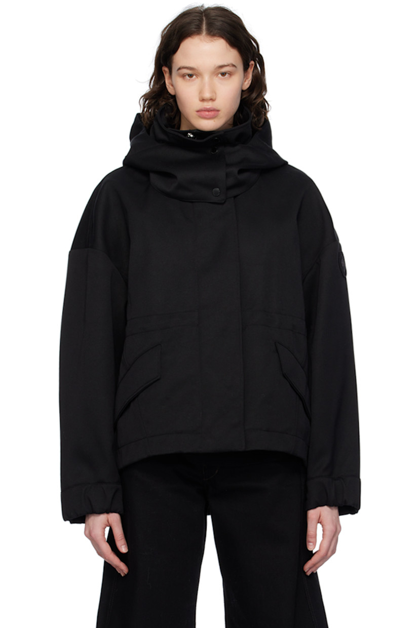 Polyester- and cotton-blend twill jacket.

· Detachable hood at stand collar
· Two-way zip closure with press-stud placket
· Flap pockets
· Droptail hem
· Metal eyelets at underarms
· Embroidered logo patch at sleeve
· Adjustable press-stud tab at elasticized cuffs
· Taped seams at interior
· Patch pockets at interior
· Bungee-style drawstring at interior waist
· Partial twill lining

Supplier color: Black