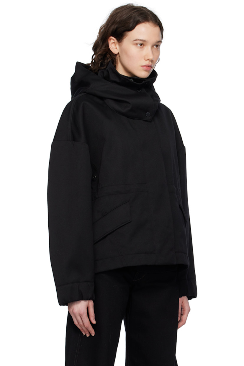 Polyester- and cotton-blend twill jacket.

· Detachable hood at stand collar
· Two-way zip closure with press-stud placket
· Flap pockets
· Droptail hem
· Metal eyelets at underarms
· Embroidered logo patch at sleeve
· Adjustable press-stud tab at elasticized cuffs
· Taped seams at interior
· Patch pockets at interior
· Bungee-style drawstring at interior waist
· Partial twill lining

Supplier color: Black