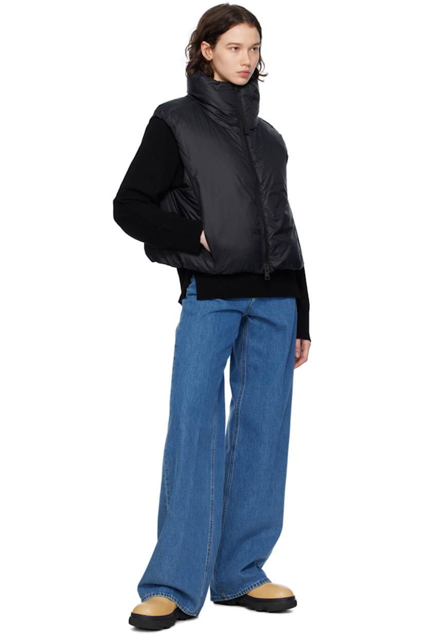 Down-filled nylon satin vest. Wind-resistant, water-repellent, and lightweight.

· Funnel neck
· Two-way zip closure
· Bungee-style drawstring at cropped hem
· Seam zip pockets
· Embroidered logo patch at back collar
· Full satin lining

Supplier color: Black

Fill: 90% duck down, 10% duck feather.