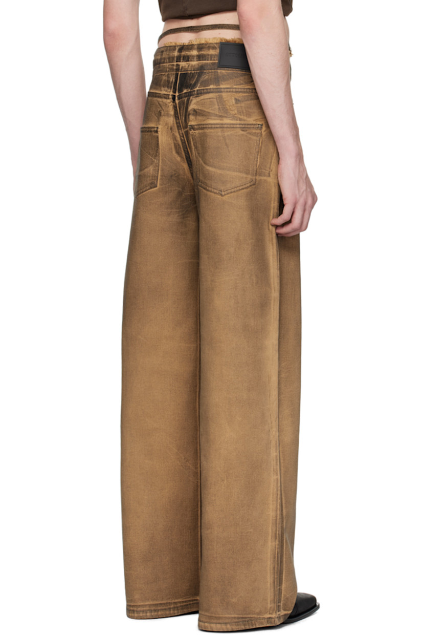 Handcrafted stretch cotton-blend denim jeans. Graphic pattern printed throughout.

· Belt loop and frayed edge at layered waistband
· Drawstring and strap at waistband
· Five-pocket styling
· Offset zip-fly
· Rubberized logo patch at back waistband
· Logo flag at back patch pocket
· Logo-engraved gunmetal-tone hardware

Wholesale exclusivity at SSENSE.

Supplier color: Brown/Black paint