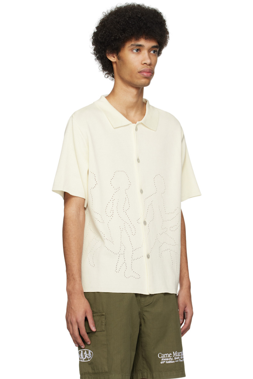 Knit mercerized organic cotton shirt.

· Rib knit spread collar
· Button closure
· Graphics perforated at front and back
· Mother-of-pearl hardware

Supplier color: Cream
