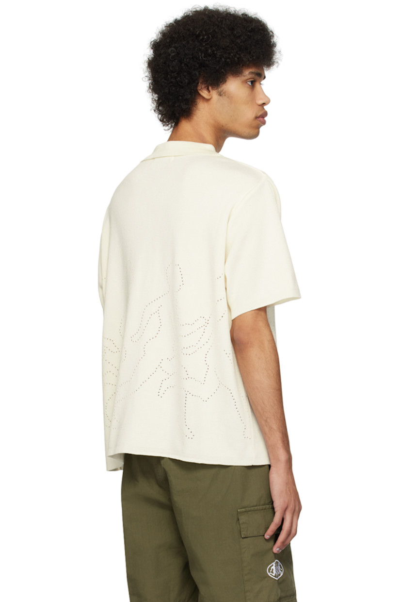 Knit mercerized organic cotton shirt.

· Rib knit spread collar
· Button closure
· Graphics perforated at front and back
· Mother-of-pearl hardware

Supplier color: Cream