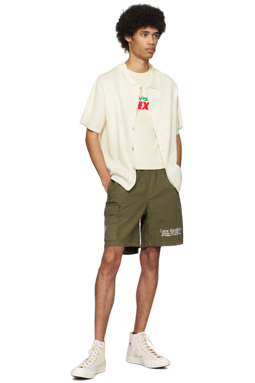 Knit mercerized organic cotton shirt.

· Rib knit spread collar
· Button closure
· Graphics perforated at front and back
· Mother-of-pearl hardware

Supplier color: Cream