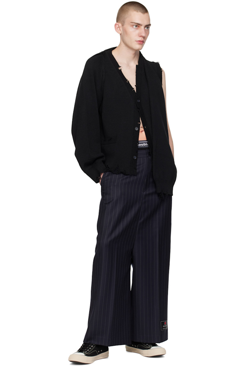 Knit polyester- and cotton-blend cardigan. Distressing, laddering, and loose thread detailing throughout.

· Rib knit Y-neck, hem, armscyes, and cuffs
· Button closure
· Patch pockets
· Integrated sleeves at back collar for alternate styling

This item is part of a limited run of 82.

Supplier color: Black