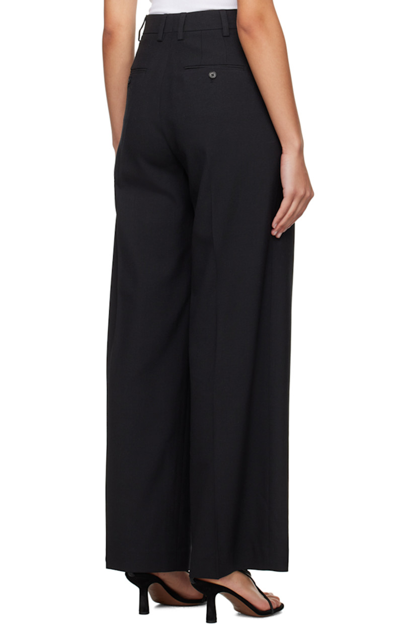 Wide-leg stretch polyester- and mulesing-free wool-blend broadcloth trousers.  

· High-rise 
· Belt loops 
· Pleats at waistband
· Four pocket styling
· Zip-fly
· Extended cuffs

Supplier color: Black