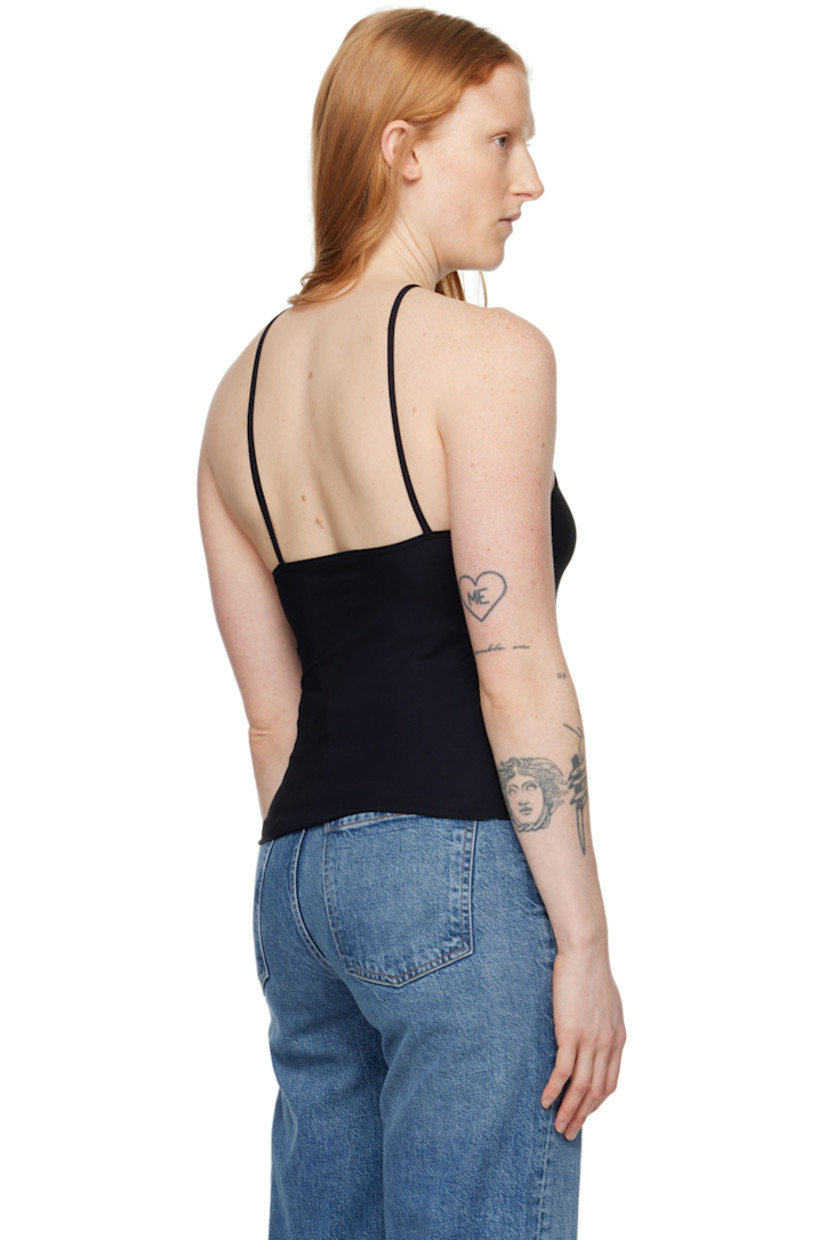 Stretch nylon jersey tank top.

· Single-shoulder construction
· Lettuce edge hem 
· Open back
· Fixed spaghetti straps

Supplier color: Black
