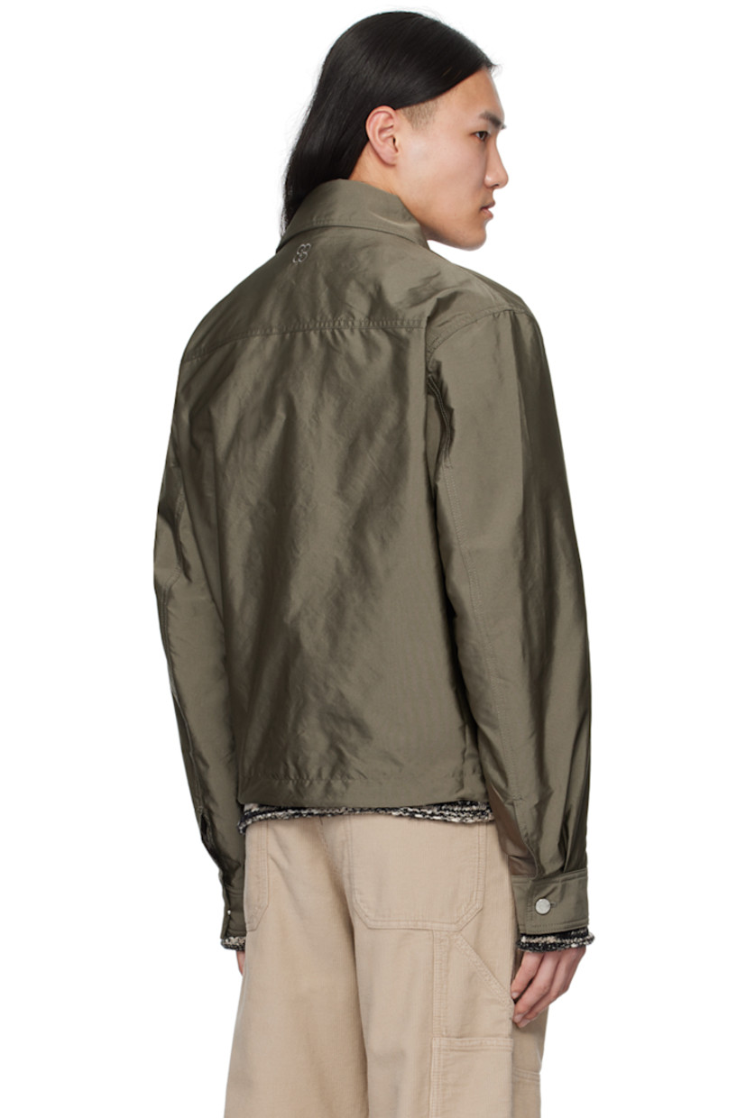 Lightweight polyester faille jacket.

· Spread collar
· Concealed button closure
· Flap pockets
· Concealed bungee-style drawstring at hem
· Single-button barrel cuffs
· Logo embroidered at back collar
· Full satin lining
· Logo-engraved silver-tone hardware

Supplier color: Dark sage