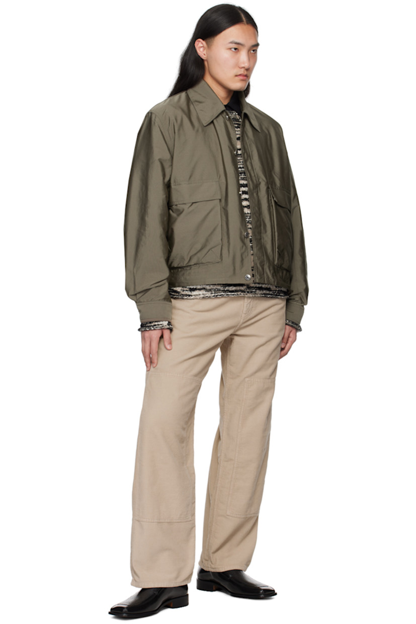 Lightweight polyester faille jacket.

· Spread collar
· Concealed button closure
· Flap pockets
· Concealed bungee-style drawstring at hem
· Single-button barrel cuffs
· Logo embroidered at back collar
· Full satin lining
· Logo-engraved silver-tone hardware

Supplier color: Dark sage