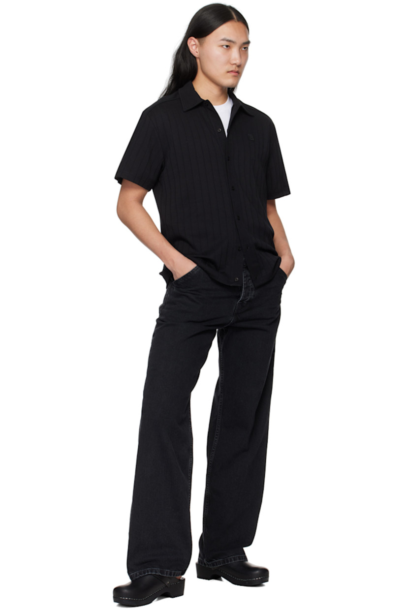 Organic cotton jersey shirt. Stripes throughout. 

· Spread collar
· Button closure
· Embroidered logo patch at chest
· Yoke sleeves

Supplier color: Black