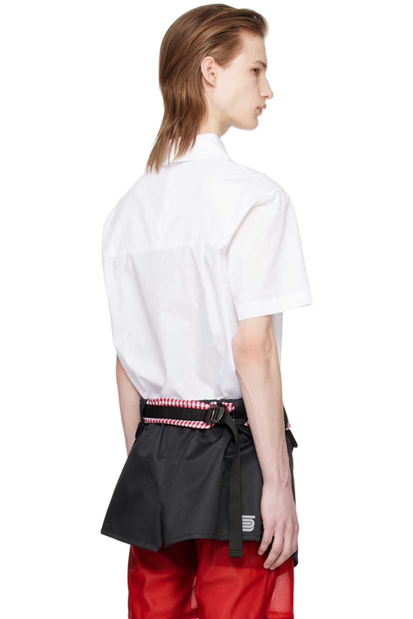 Cotton poplin shirt. 

· Logo-embroidered tie-style trim at spread collar 
· Box pleat at front 
· Vented back collar
· Zip closure and pleats at back

Supplier color: White