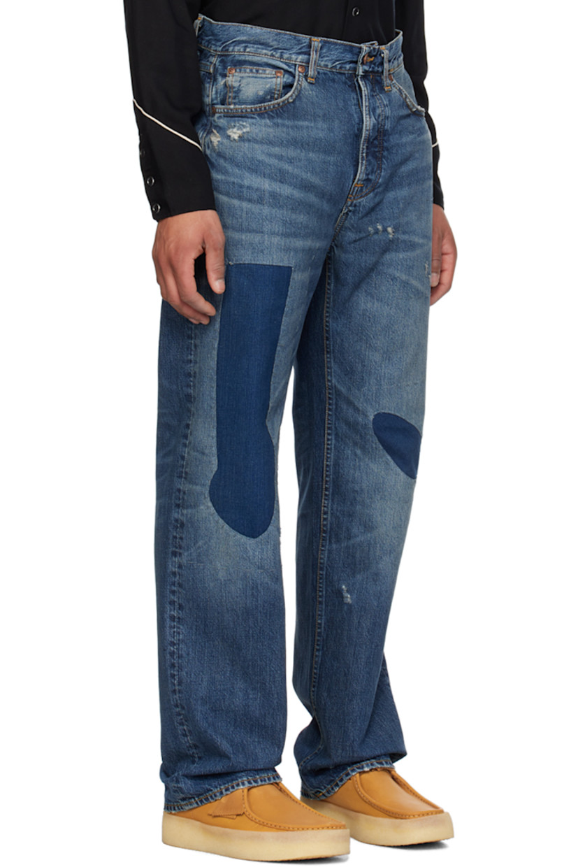 Wide-leg 14.2 oz non-stretch denim jeans. Fading, whiskering, and distressing throughout.

· High-rise
· Belt loops
· Five-pocket styling
· Button-fly
· Patchwork at front
· Logo patch at back waistband and pocket
· Contrast stitching in orange

Supplier color: Patch work