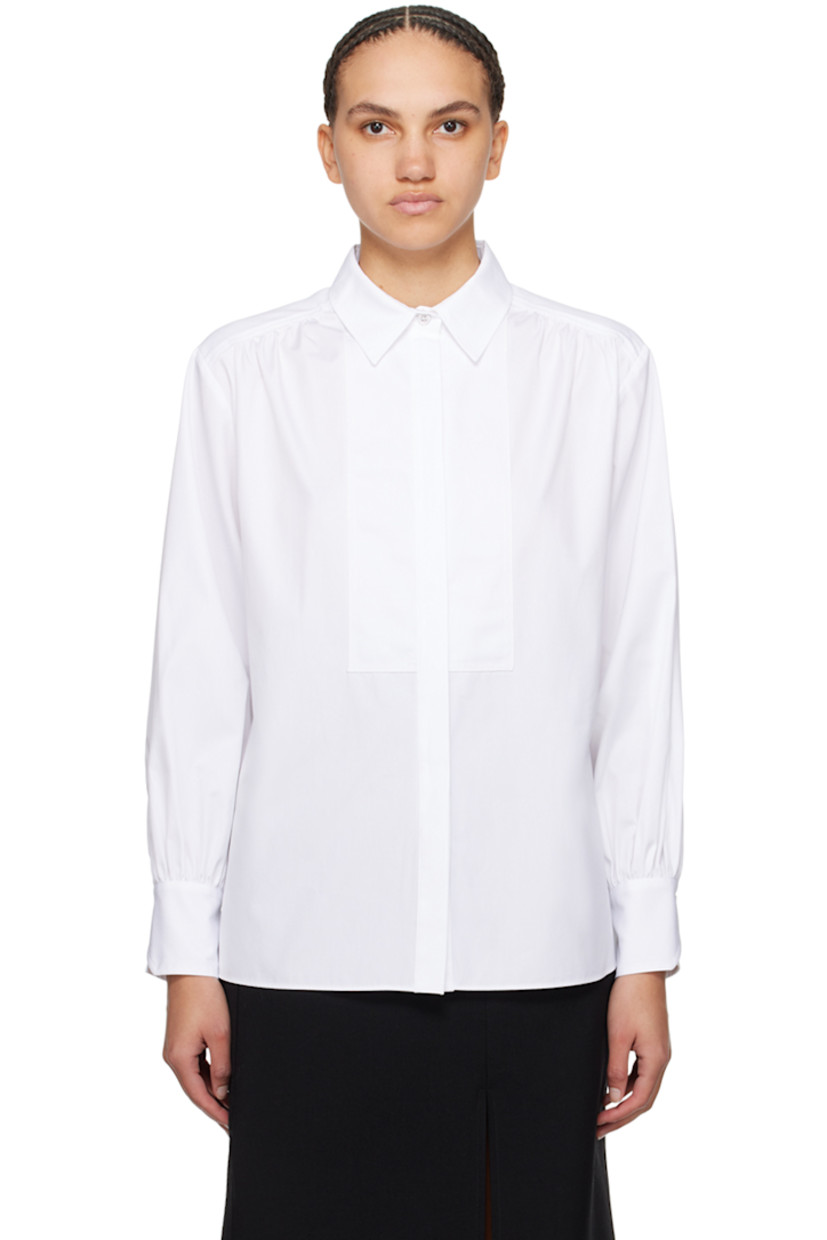Cotton poplin shirt. Gathering throughout.

· Spread collar
· Button closure
· Piqué trim at front
· Vented side seams
· Single-button barrel cuffs
· Box pleat at back yoke

Supplier color: White