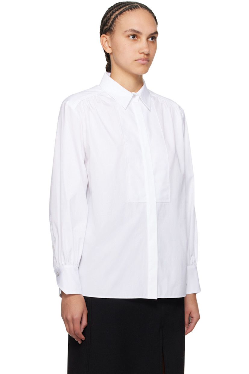 Cotton poplin shirt. Gathering throughout.

· Spread collar
· Button closure
· Piqué trim at front
· Vented side seams
· Single-button barrel cuffs
· Box pleat at back yoke

Supplier color: White