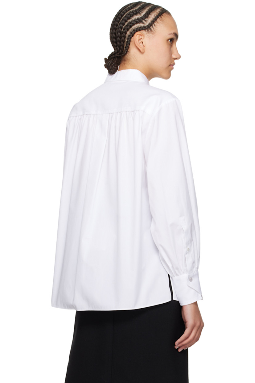 Cotton poplin shirt. Gathering throughout.

· Spread collar
· Button closure
· Piqué trim at front
· Vented side seams
· Single-button barrel cuffs
· Box pleat at back yoke

Supplier color: White