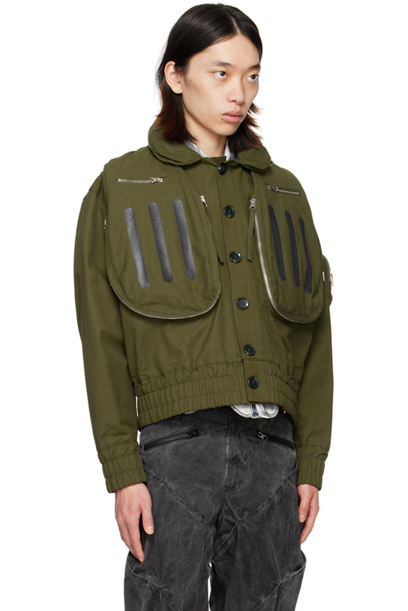 Cotton- and nylon-blend twill bomber jacket.

· Packable hood at spread collar
· Button closure
· Zip pockets and stripes printed at front
· Elasticized hem and cuffs
· Zip pocket, pen slots, and logo flag at sleeve
· Welt pocket at interior
· Full mesh lining

Supplier color: Olive