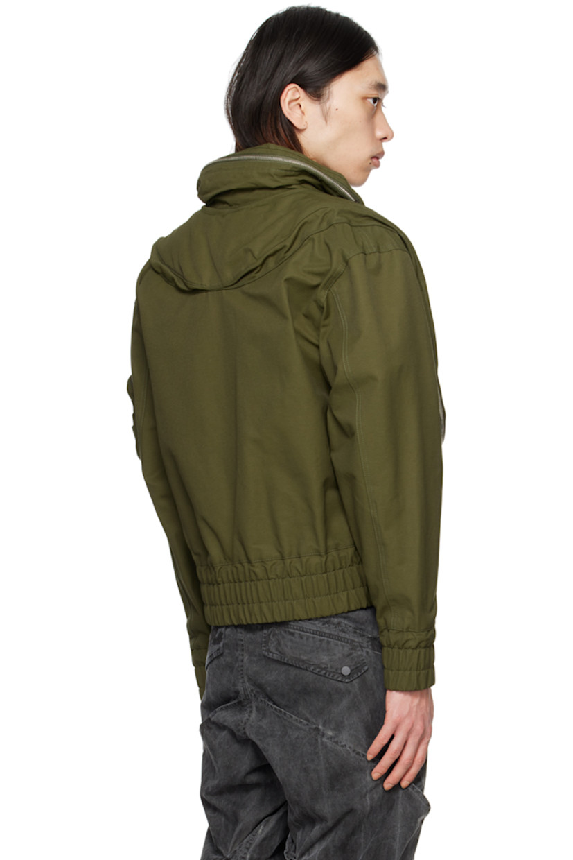 Cotton- and nylon-blend twill bomber jacket.

· Packable hood at spread collar
· Button closure
· Zip pockets and stripes printed at front
· Elasticized hem and cuffs
· Zip pocket, pen slots, and logo flag at sleeve
· Welt pocket at interior
· Full mesh lining

Supplier color: Olive