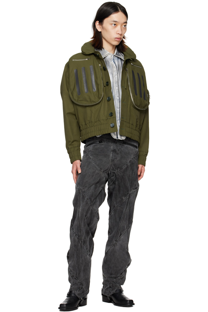 Cotton- and nylon-blend twill bomber jacket.

· Packable hood at spread collar
· Button closure
· Zip pockets and stripes printed at front
· Elasticized hem and cuffs
· Zip pocket, pen slots, and logo flag at sleeve
· Welt pocket at interior
· Full mesh lining

Supplier color: Olive
