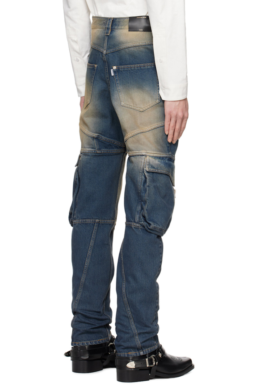 Non-stretch denim jeans. Fading throughout.

· Paneled construction
· Belt loops
· Four-pocket styling
· Zip-fly
· Panel and inverted pleats at front
· Cargo and zip pocket at outseams
· Leather logo patch at back waistband
· Logo flag at back pocket
· Contrast stitching in orange
 
Supplier color: Washed blue