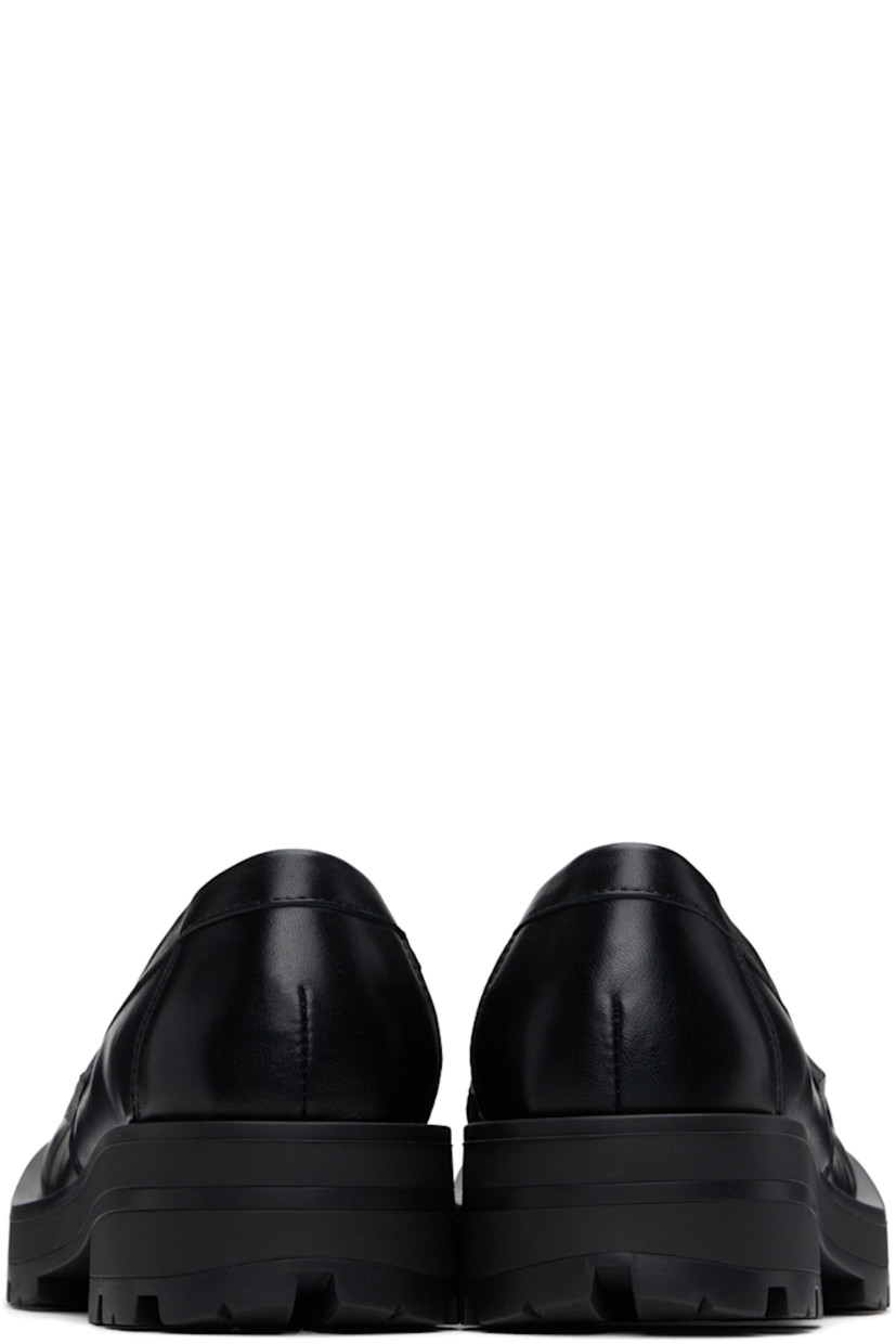 Buffed leather loafers in black.

· Sculptural square toe
· Strap with cutout at vamp
· Buffed leather lining
· Rubber block heel
· Stacked leather and foam rubber midsole
· Treaded rubber sole
· Heel: H1.75"

Supplier color: Black