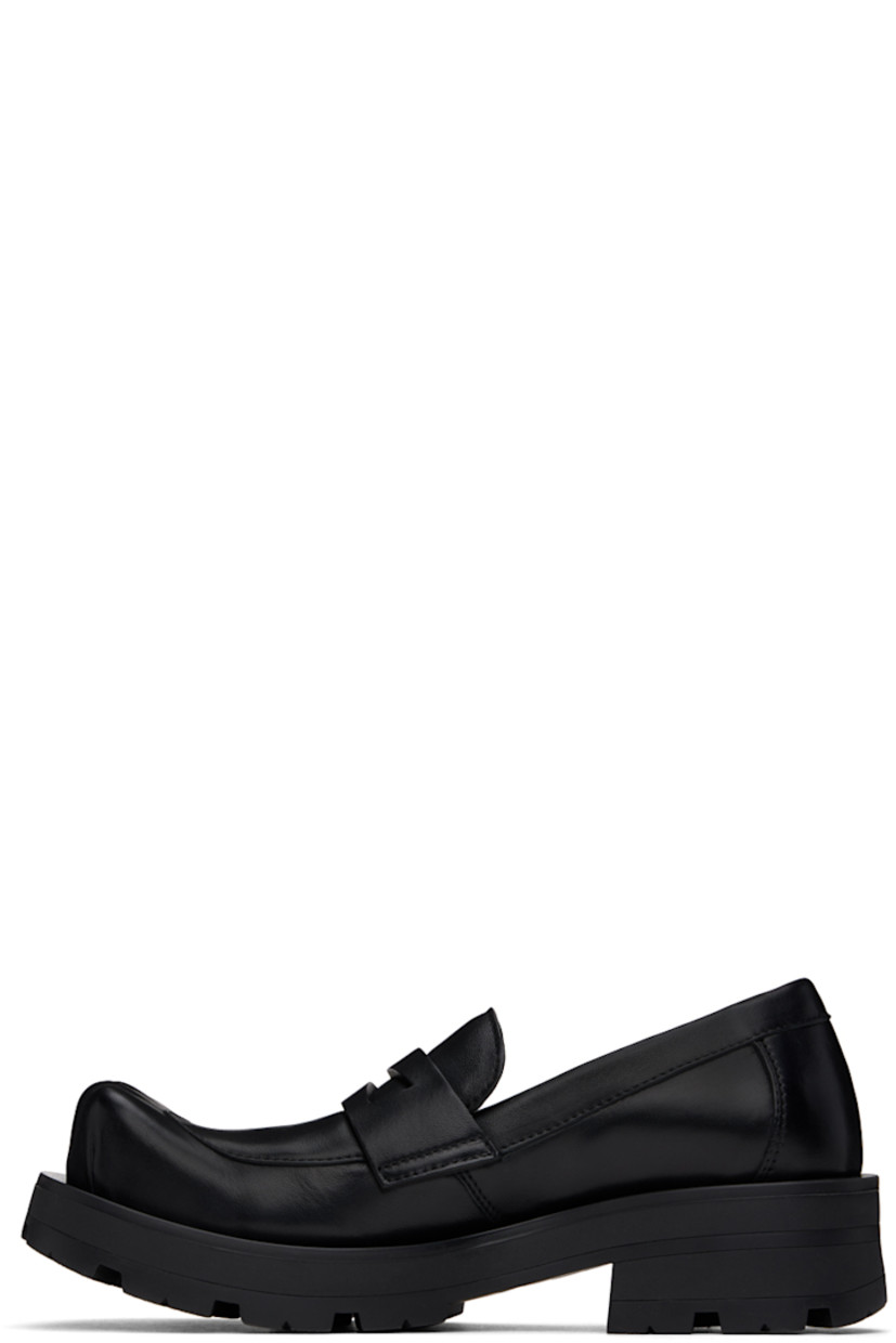 Buffed leather loafers in black.

· Sculptural square toe
· Strap with cutout at vamp
· Buffed leather lining
· Rubber block heel
· Stacked leather and foam rubber midsole
· Treaded rubber sole
· Heel: H1.75"

Supplier color: Black