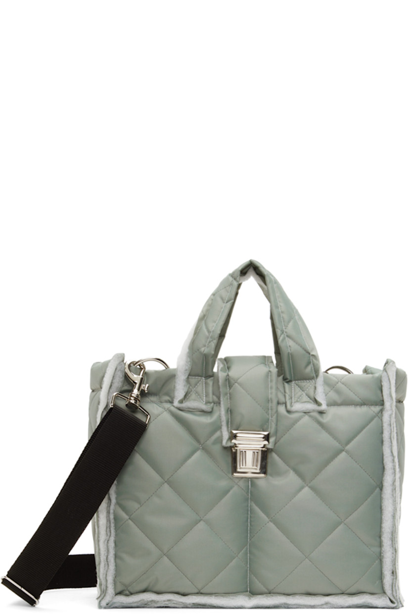 Padded quilted canvas messenger bag in gray.

· Raw edges throughout 
· Twin shoulder straps
· Detachable and adjustable crossbody strap
· Press-release foldover strap
· Patch pockets at interior
· Full quilted canvas lining 
· H10" x W12" x D5.5"

Available exclusively at SSENSE.

Supplier color: Sage