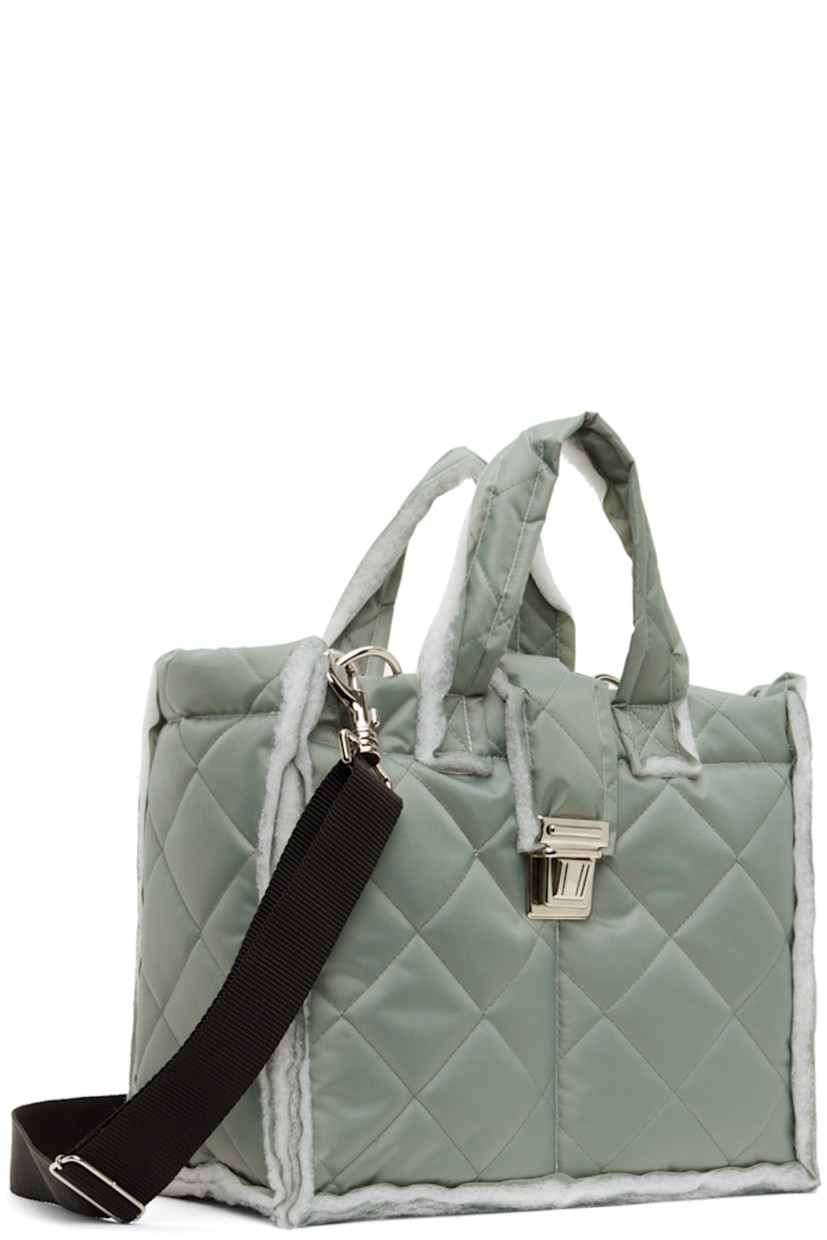 Padded quilted canvas messenger bag in gray.

· Raw edges throughout 
· Twin shoulder straps
· Detachable and adjustable crossbody strap
· Press-release foldover strap
· Patch pockets at interior
· Full quilted canvas lining 
· H10" x W12" x D5.5"

Available exclusively at SSENSE.

Supplier color: Sage