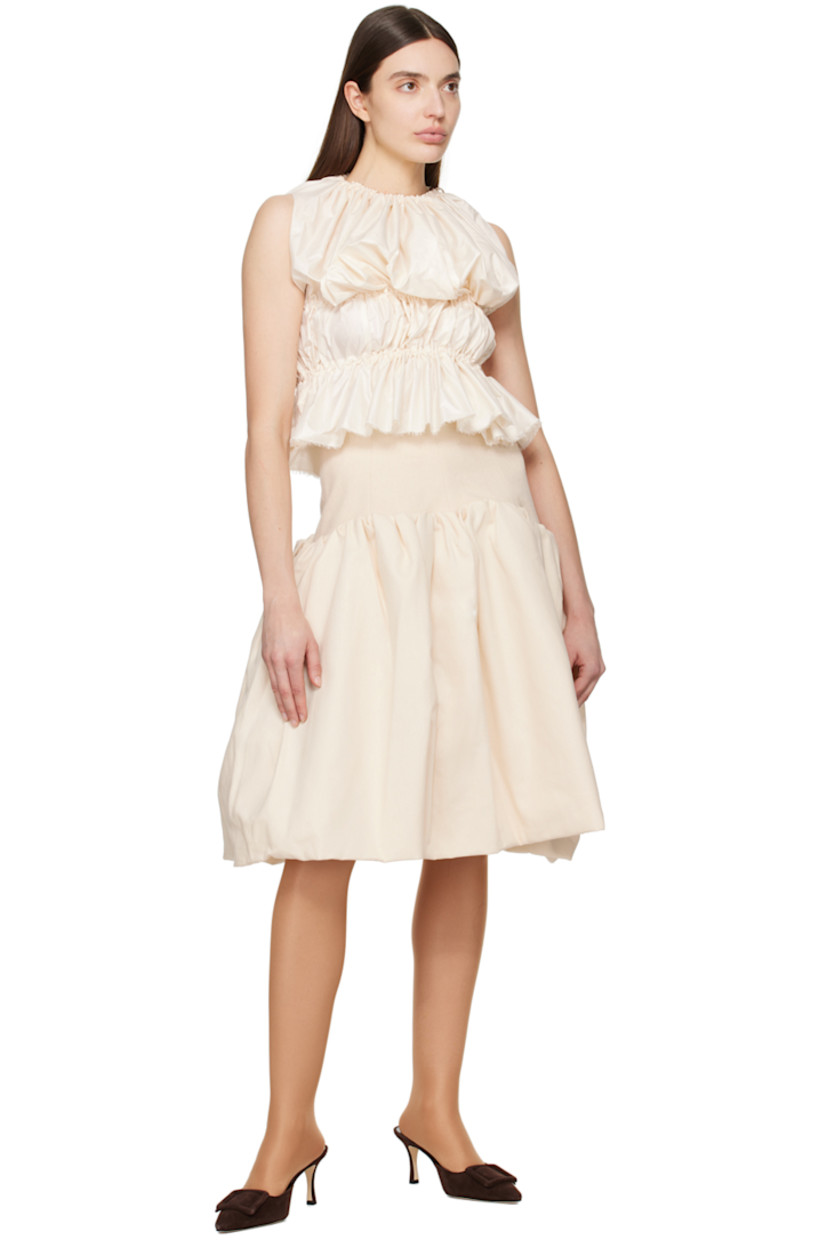 Polyester taffeta tank top. Bungee-style drawstrings and ruching throughout. 

· Gathering at elasticized crewneck
· Frayed edge at hem

Supplier color: Creme
