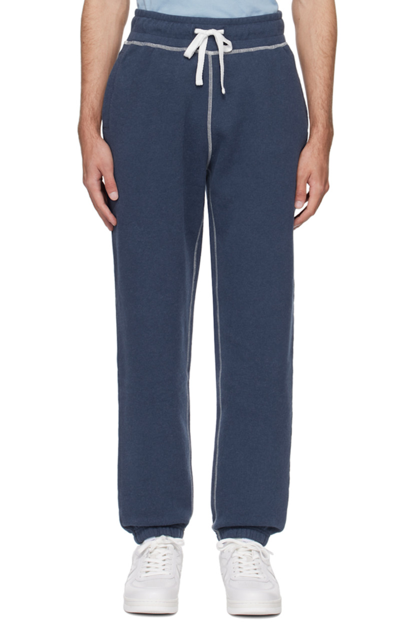 Cotton fleece sweatpants. 

· Drawstring at elasticized waistband
· Three-pocket styling
· Elasticized cuffs
· Contrast overlock stitching in white

Supplier color: Navy melange
