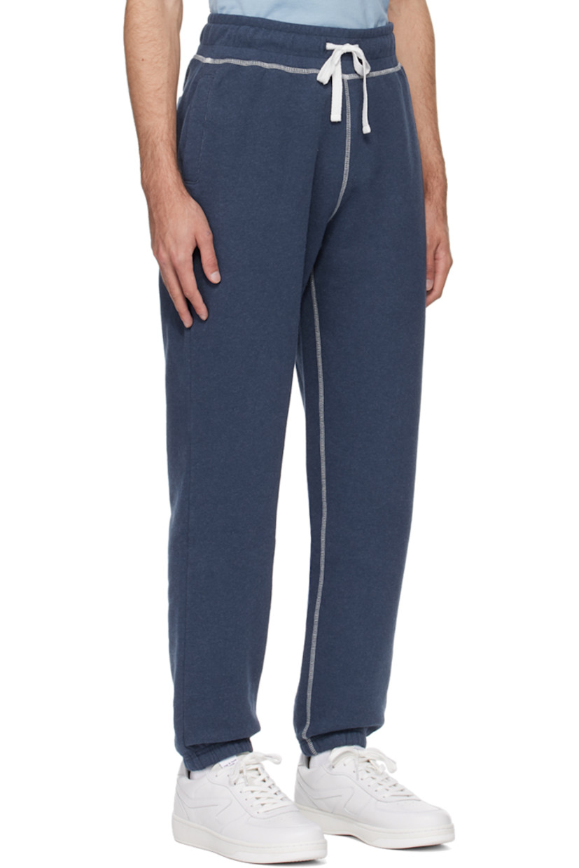 Cotton fleece sweatpants. 

· Drawstring at elasticized waistband
· Three-pocket styling
· Elasticized cuffs
· Contrast overlock stitching in white

Supplier color: Navy melange
