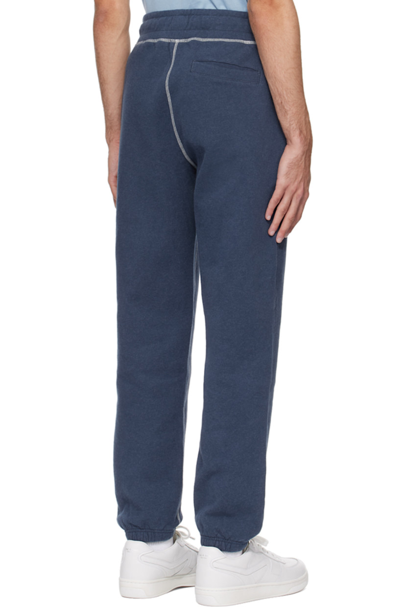 Cotton fleece sweatpants. 

· Drawstring at elasticized waistband
· Three-pocket styling
· Elasticized cuffs
· Contrast overlock stitching in white

Supplier color: Navy melange