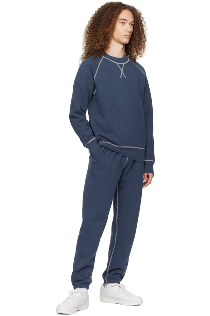 Cotton fleece sweatpants. 

· Drawstring at elasticized waistband
· Three-pocket styling
· Elasticized cuffs
· Contrast overlock stitching in white

Supplier color: Navy melange